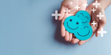 Hands holding blue happy smile face, good feedback rating, positive customer review, experience, satisfaction survey, smiley mental health, child wellness, world mental health day on blue background
