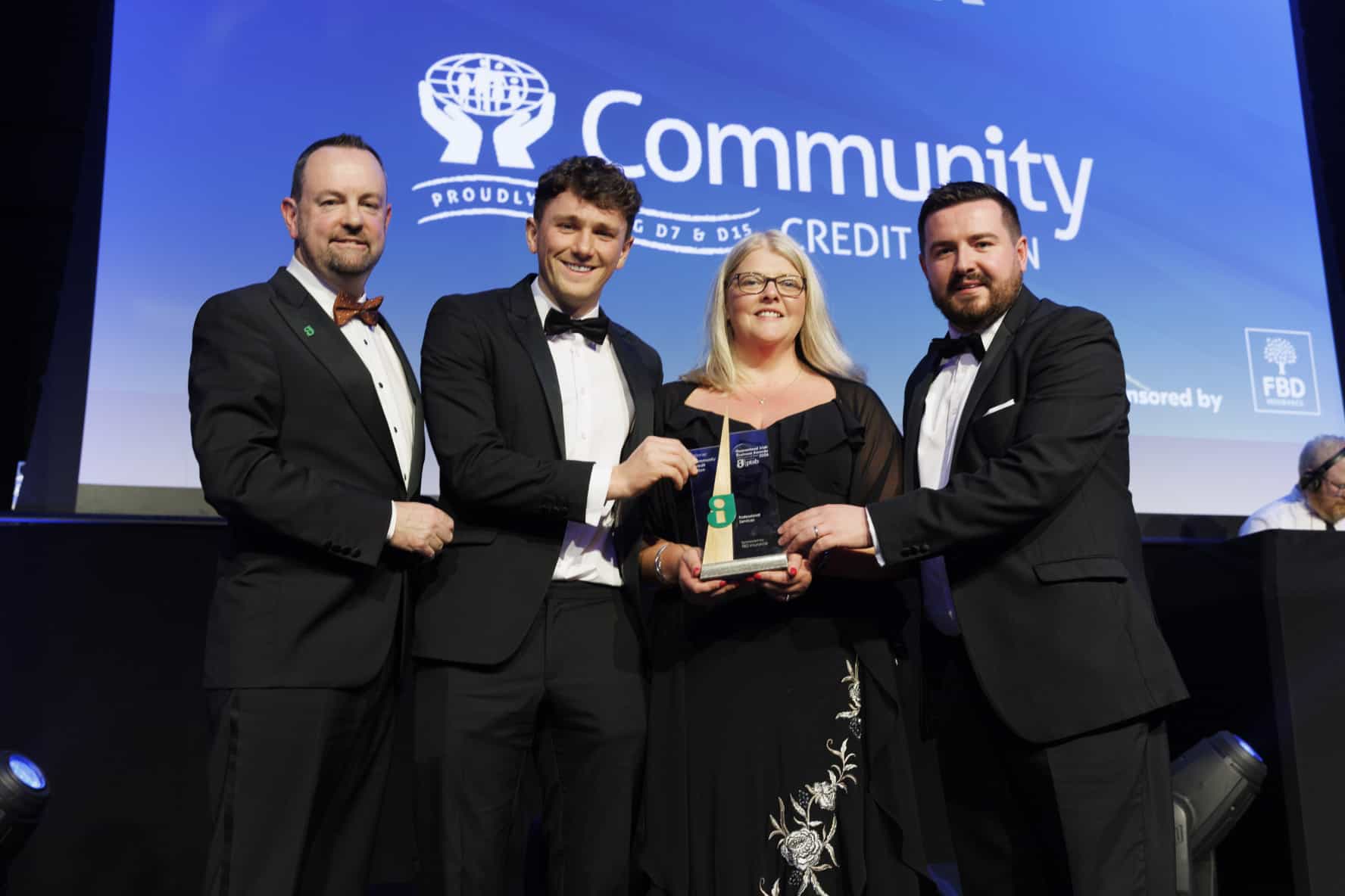 Pictured John Reade, FBD Insurance with the team from Community Credit Union, winner of Professional Services, sponsored by FBD Insurance at the 2024 Guaranteed Irish Business Awards, proudly supported by PTSB.