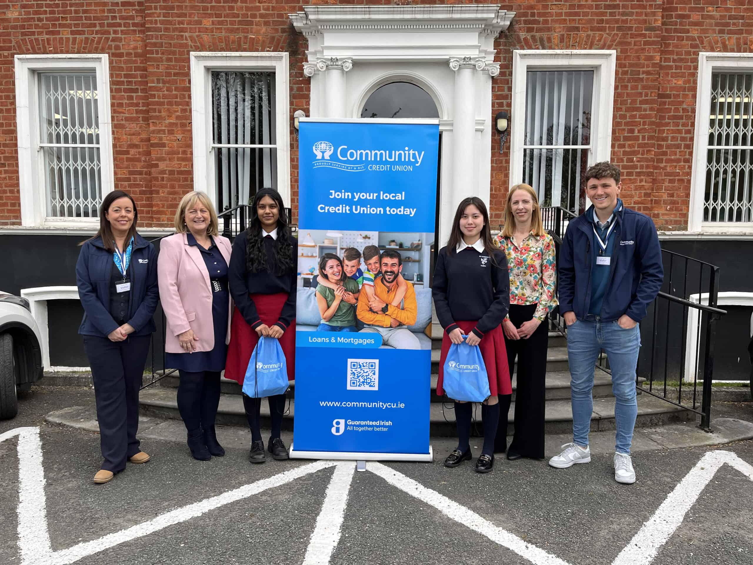 Community CU Staff standing outside St Dominics College Cabra fro a picture with the two students that will be representing the school at this years International Space Development Confernece.